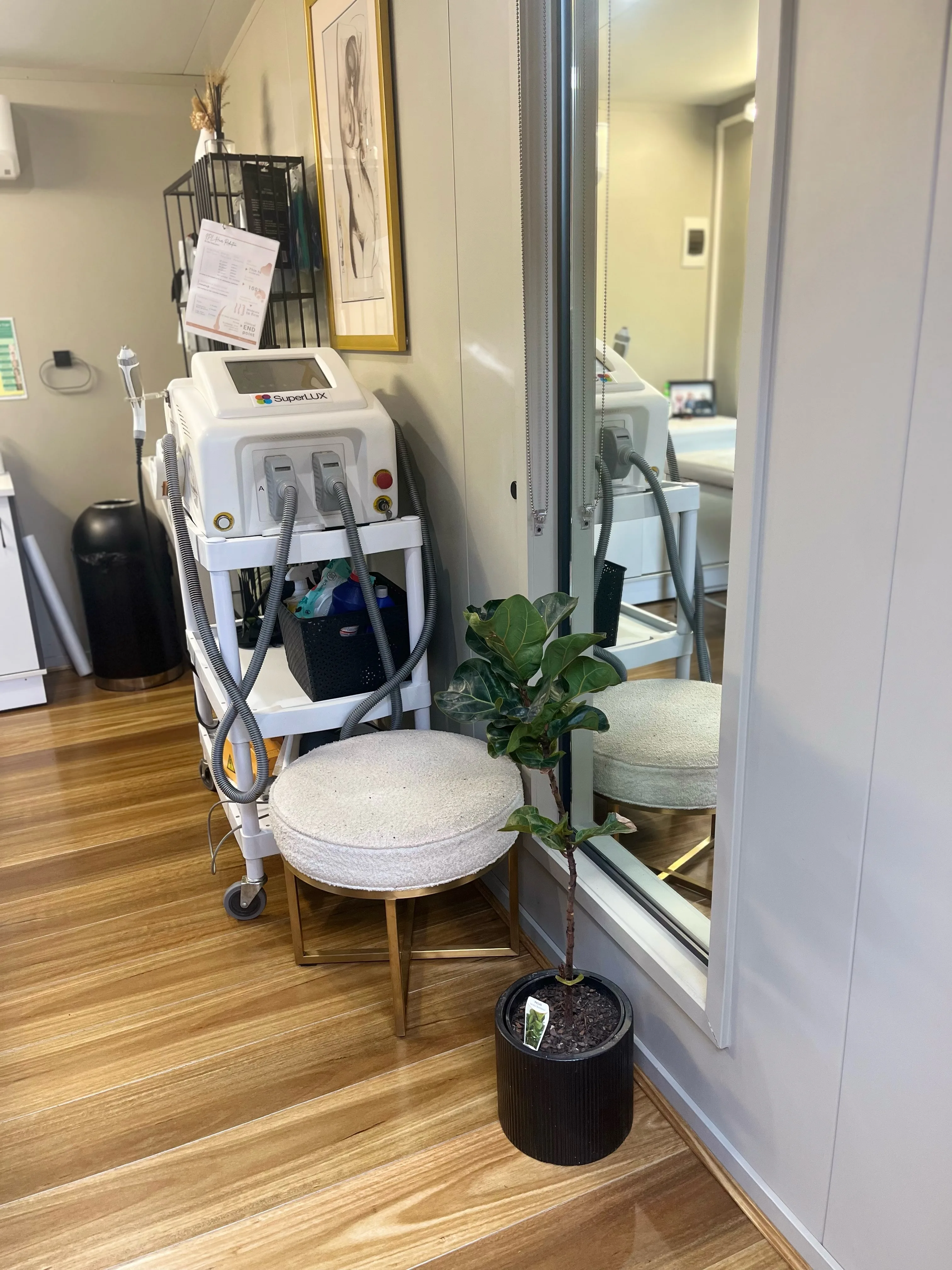 SuperLUX IPL device and boucle brass stool in the treatment room